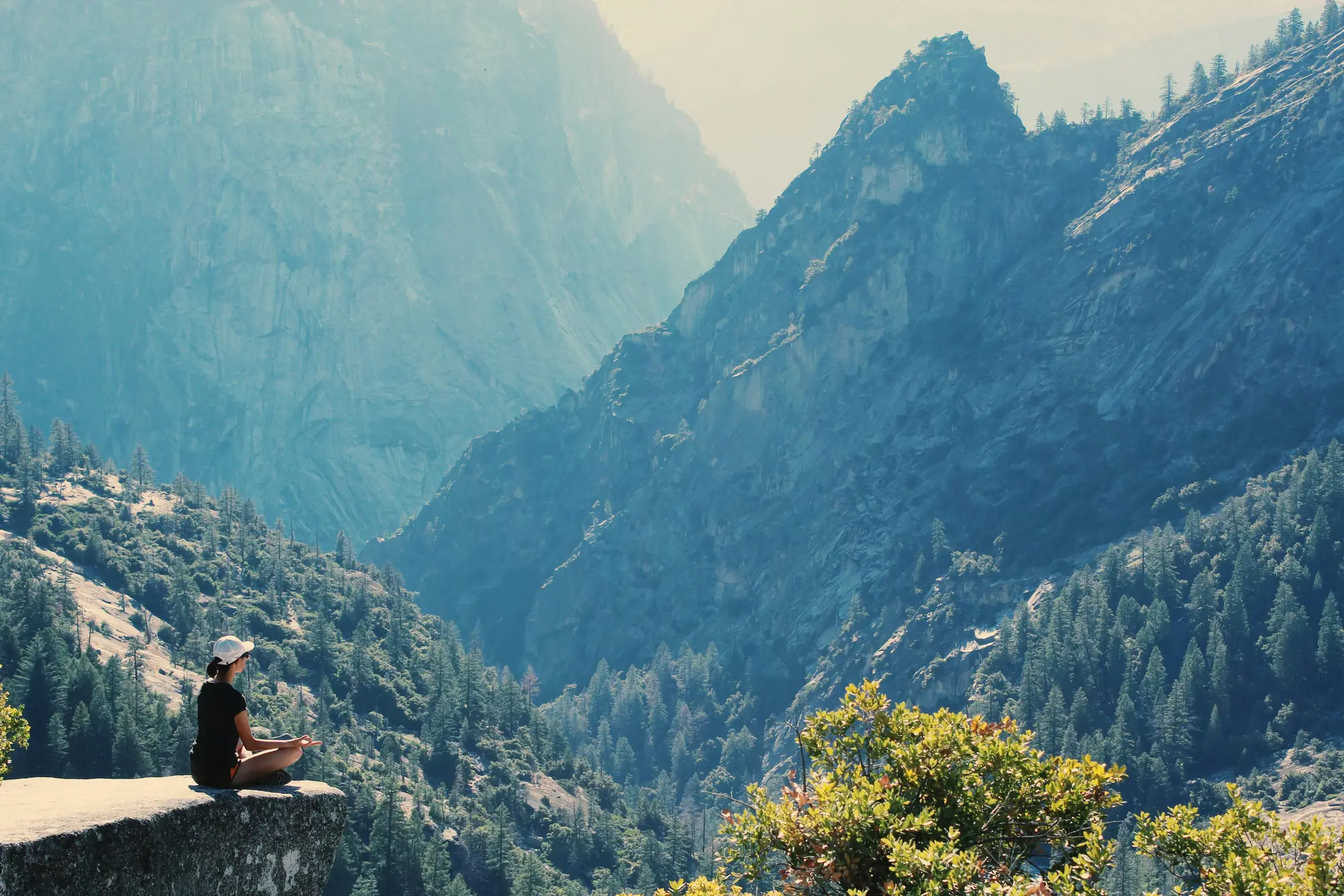 Man peacefully doing Yoga, on a mountain's edge