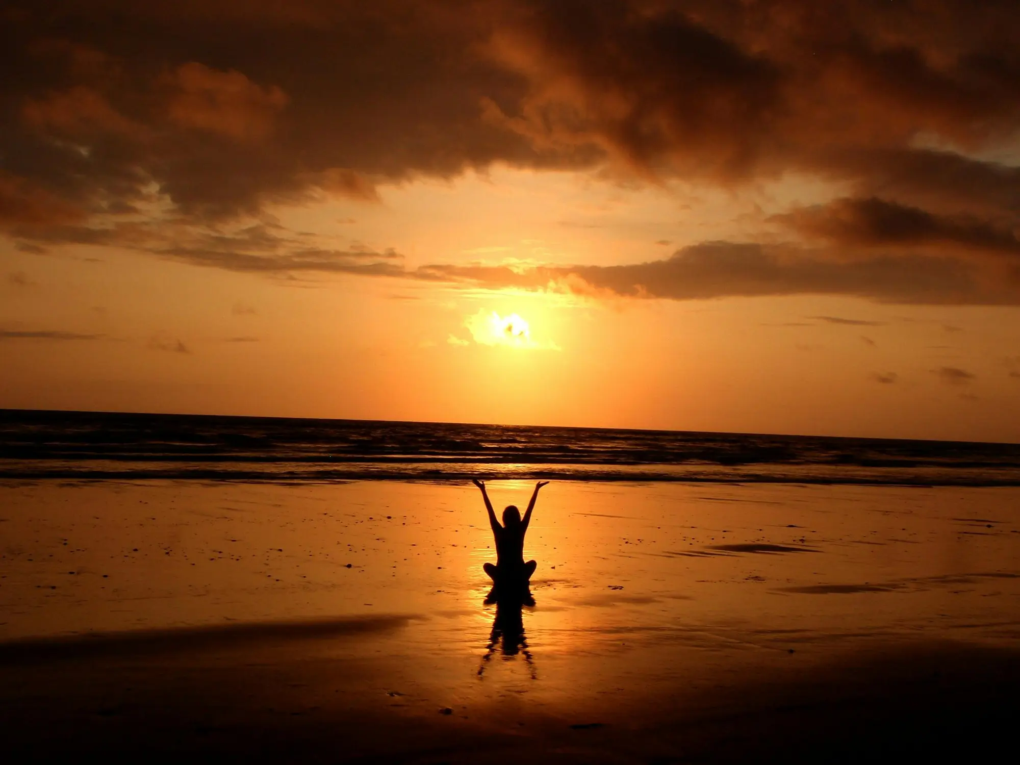 woman doing a yoga on sea shore